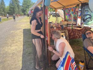 Festival attendees interacting with a colorful hand-painted installation booth at SOAK