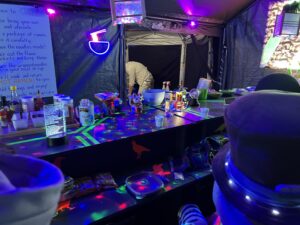 Late night ramen camp with UV blacklights and neon decorations at SOAK festival