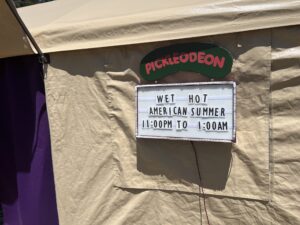 Pickleodeon pickle-shaped sign above movie marquee displaying Wet Hot American Summer late night screening